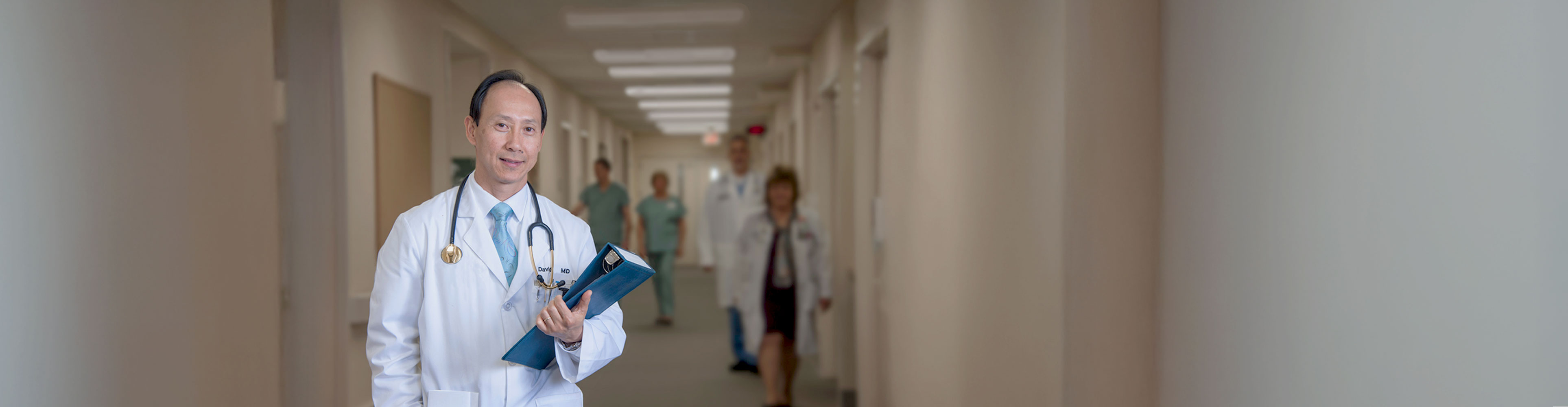 Image of doctor standing in hospital hallway